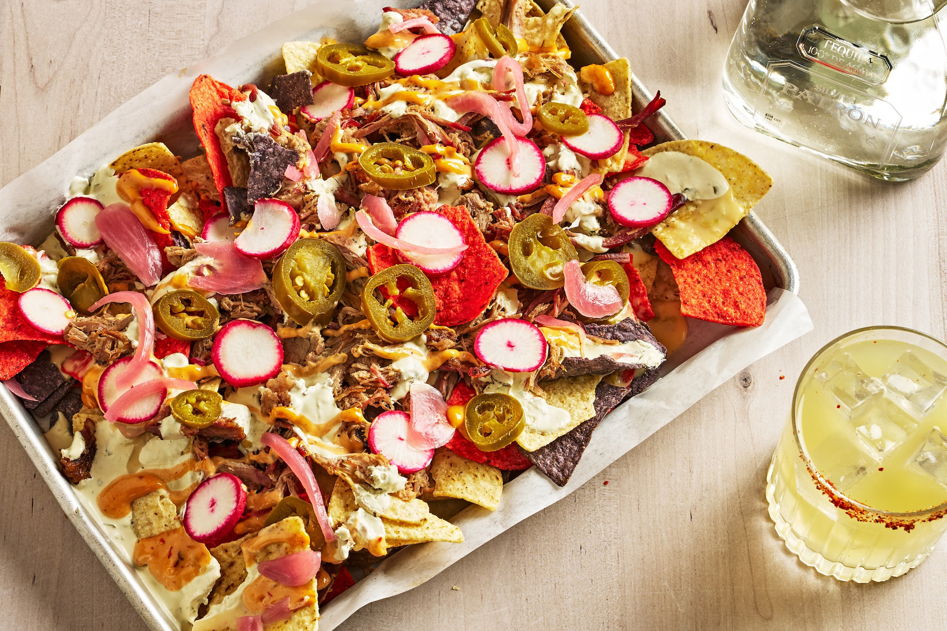 Plate of nachos and margarita on a table top